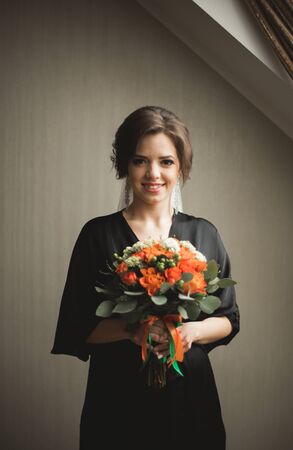 Luxury bride in black robe posing while preparing for the wedding ceremony.の写真素材