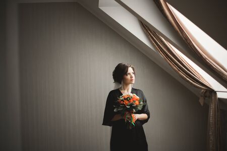 Luxury bride in black robe posing while preparing for the wedding ceremony.の写真素材