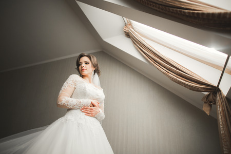 Luxury bride in white dress posing while preparing for the wedding ceremony.の写真素材