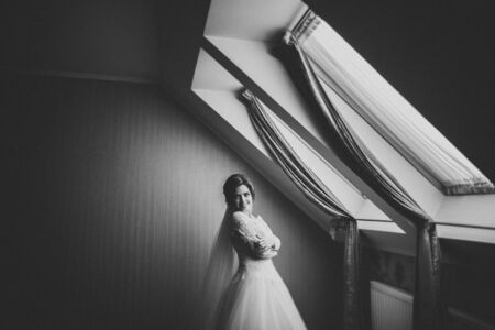 Luxury bride in white dress posing while preparing for the wedding ceremony.の写真素材