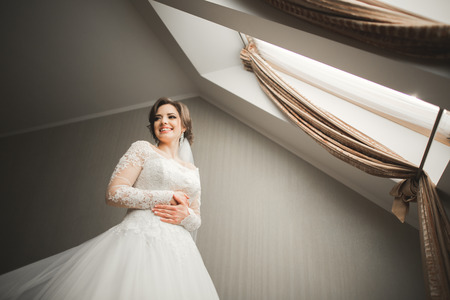 Luxury bride in white dress posing while preparing for the wedding ceremony.の写真素材