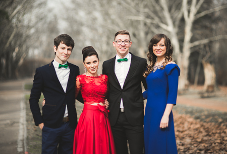 Bridesmaids and groomsmen of wedding couple posing in park.の写真素材