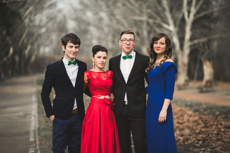 Bridesmaids and groomsmen of wedding couple posing in park.の写真素材