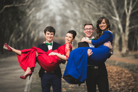 Bridesmaids and groomsmen of wedding couple posing in park.の写真素材