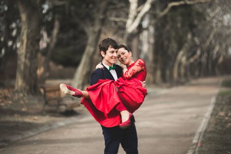 Bridesmaid and groomsman of wedding couple posing in park.の写真素材
