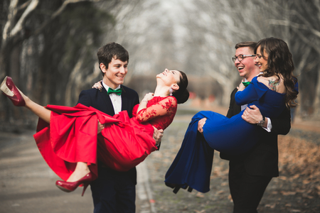 Bridesmaids and groomsmen of wedding couple posing in park.の写真素材