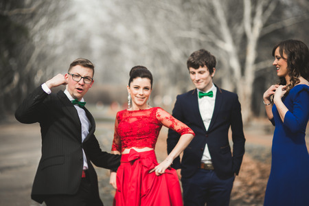 Bridesmaids and groomsmen of wedding couple posing in park.の写真素材