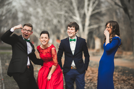 Bridesmaids and groomsmen of wedding couple posing in park.の写真素材