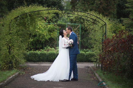 Happy wedding couple in a botanical park.の写真素材