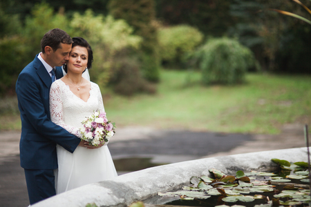 Happy wedding couple in a botanical park.の写真素材