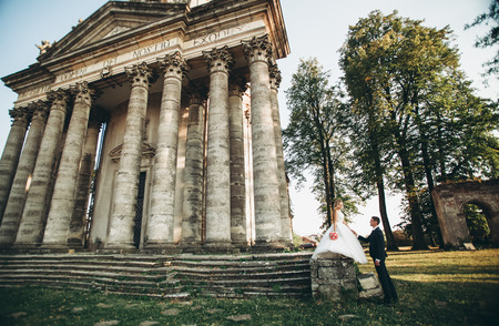 Beautiful romantic wedding couple of newlyweds near old castle.の写真素材