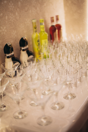 Different alcohol drinks in goblets and wine glasses on wedding buffet table.の写真素材