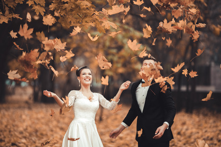 Luxury married wedding couple, bride and groom posing in park autumn.の写真素材