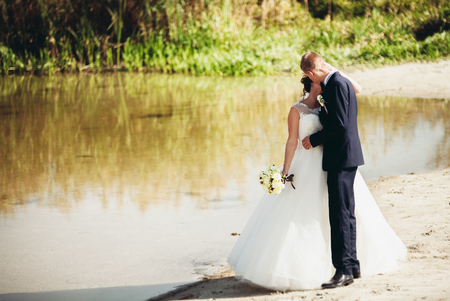 married young wedding couple near lake.の写真素材
