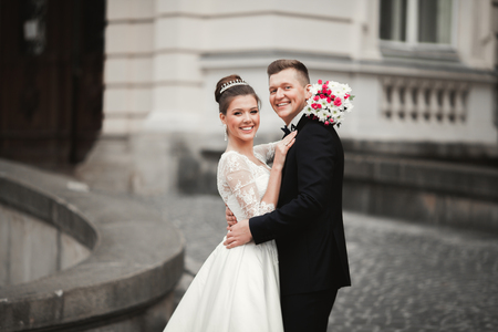 Luxury married wedding couple, bride and groom posing in old city.の写真素材