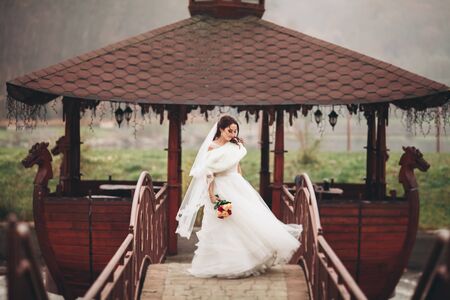 Beautiful luxury bride posing with a bouquet outdoors.の写真素材
