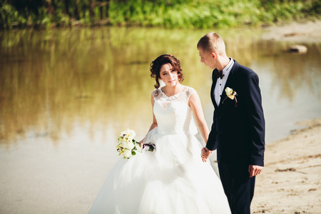 married young wedding couple near lake.の写真素材