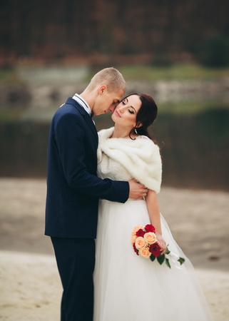 married young wedding couple near lake.の写真素材