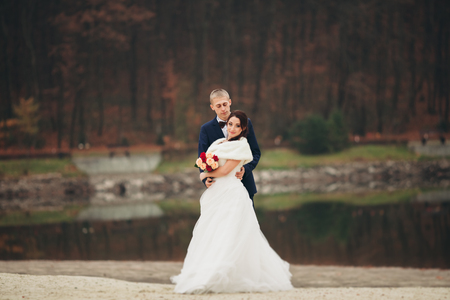 married young wedding couple near lake.の写真素材
