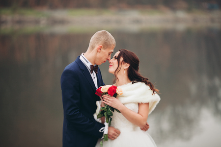married young wedding couple near lake.の写真素材