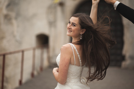Happy wedding couple hugging and smiling each other on the background gorgeous plants in castle.の写真素材
