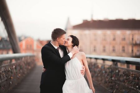 Gorgeous wedding couple, bride and groom on bridge in Krakow.の写真素材