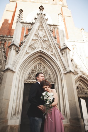 Elegant beautiful wedding couple posing near a church. Krakow.の写真素材