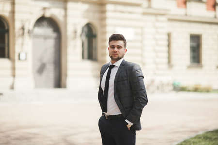Handsome stylish young businessman posing portrait outdoor.の写真素材