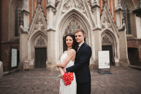 Bride and groom on the background of beautiful church.の写真素材
