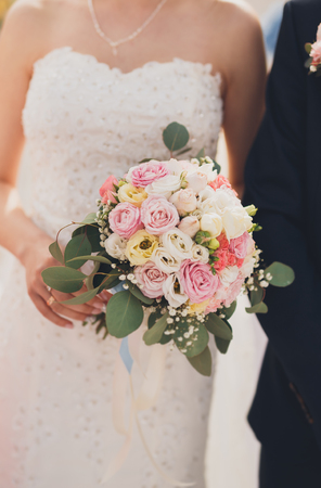 Pretty good wedding bouquet of various flowers in hand.の写真素材