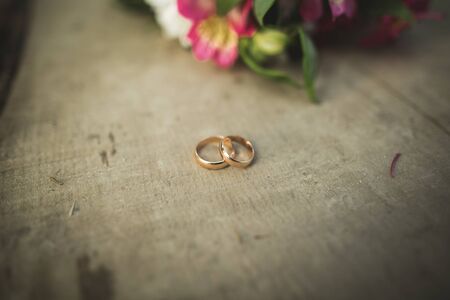 Pretty wedding bouquet of various flowers with rings.の写真素材