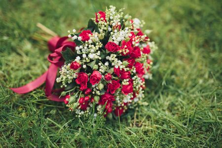 Bouquet of beautiful flowers and greenery on the green grass.の写真素材