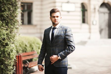 Handsome stylish young businessman posing portrait outdoor.の写真素材