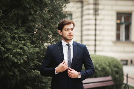 Handsome stylish young businessman posing portrait outdoor.の写真素材