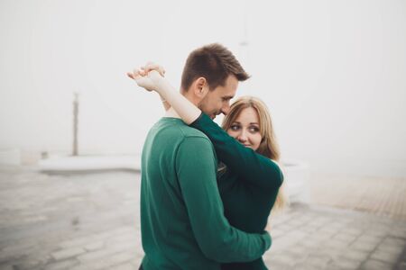 Lovely couple kissing and hugging on a sea dock.の写真素材