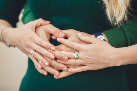 Happy couple holding hands in the sunset.の写真素材