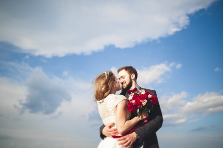 Married wedding couple standing on a wharf over the sea.の写真素材