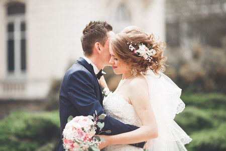 wedding couple is standing and kissing in the streets of old city.の写真素材