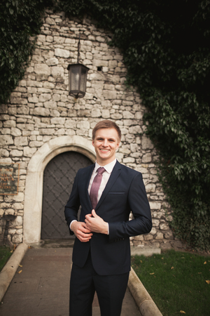Luxury groom prepares for wedding in park.の写真素材