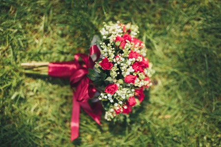 Bouquet of beautiful flowers and greenery is on the green grass.の写真素材