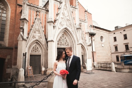 Wedding couple, bride and groom near a church in Krakow.の写真素材