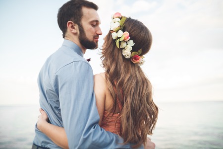 Beautiful loving couple, pride with long dress walking on pier.の写真素材