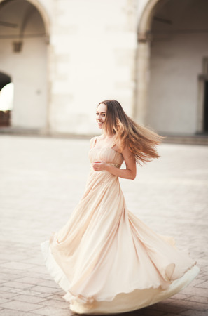Beautiful girl with long hair posing in old castle with columns. Krakow Vavel.の写真素材