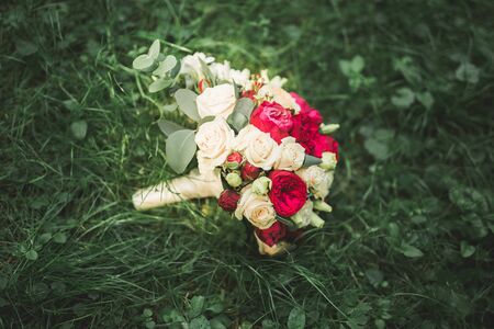 Bouquet of beautiful flowers and greenery is on the green grass.の写真素材