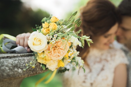 Perfect wedding couple holding luxury bouquet of flowers.の写真素材