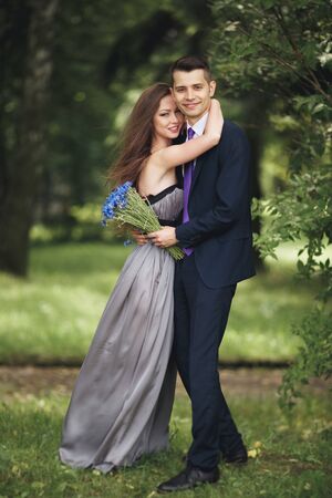 Handsome young couple posing outdoors after ceremony.の写真素材