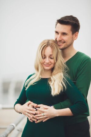 Lovely couple kissing and hugging on a sea dock.の写真素材