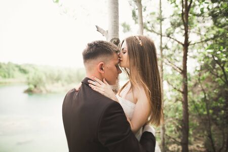 Kissing wedding couple in spring nature close-up portrait.の写真素材