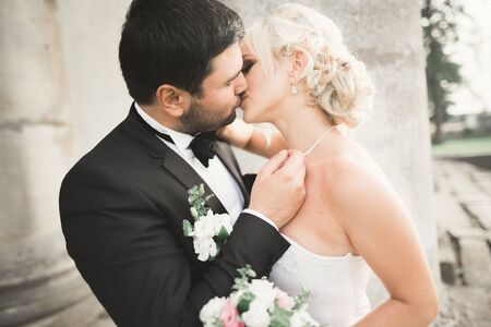 Kissing wedding couple in spring nature close-up portrait.の写真素材
