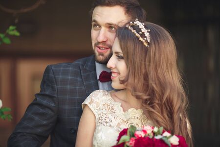Kissing wedding couple in spring nature close-up portrait.の写真素材